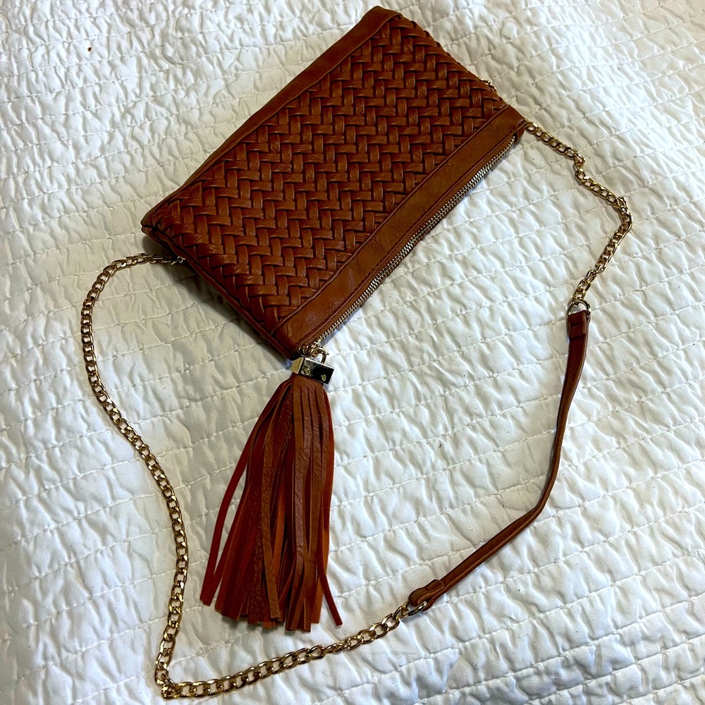 Clutch with chain strap for shoulder or cross body wear.